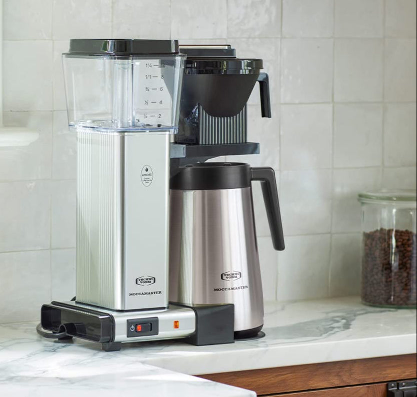Coffee machine and thermal carafe on a kitchen counter.
