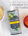 Tea canister labeled 'All Day Earl Grey' with lemon and biscuit design, surrounded by tea and cookies.