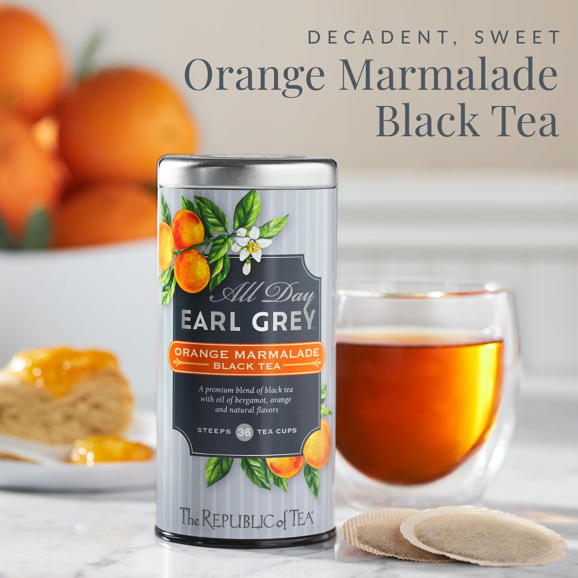 Can of Earl Grey Orange Marmalade Black Tea with a glass of tea and oranges in the background