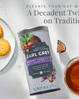 Tea canister with biscuits and tea on a light background