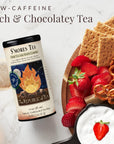 S'mores tea package with a plate of strawberries, graham crackers, and pretzels on a marble background.