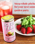 Iced tea can with strawberries on a plate next to a Strawberry Basil tea canister displayed on a wooden table