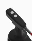 Black handheld device with a cord on a white background