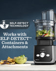 Vitamix food processor with ingredients on a counter, featuring self-detect technology text.