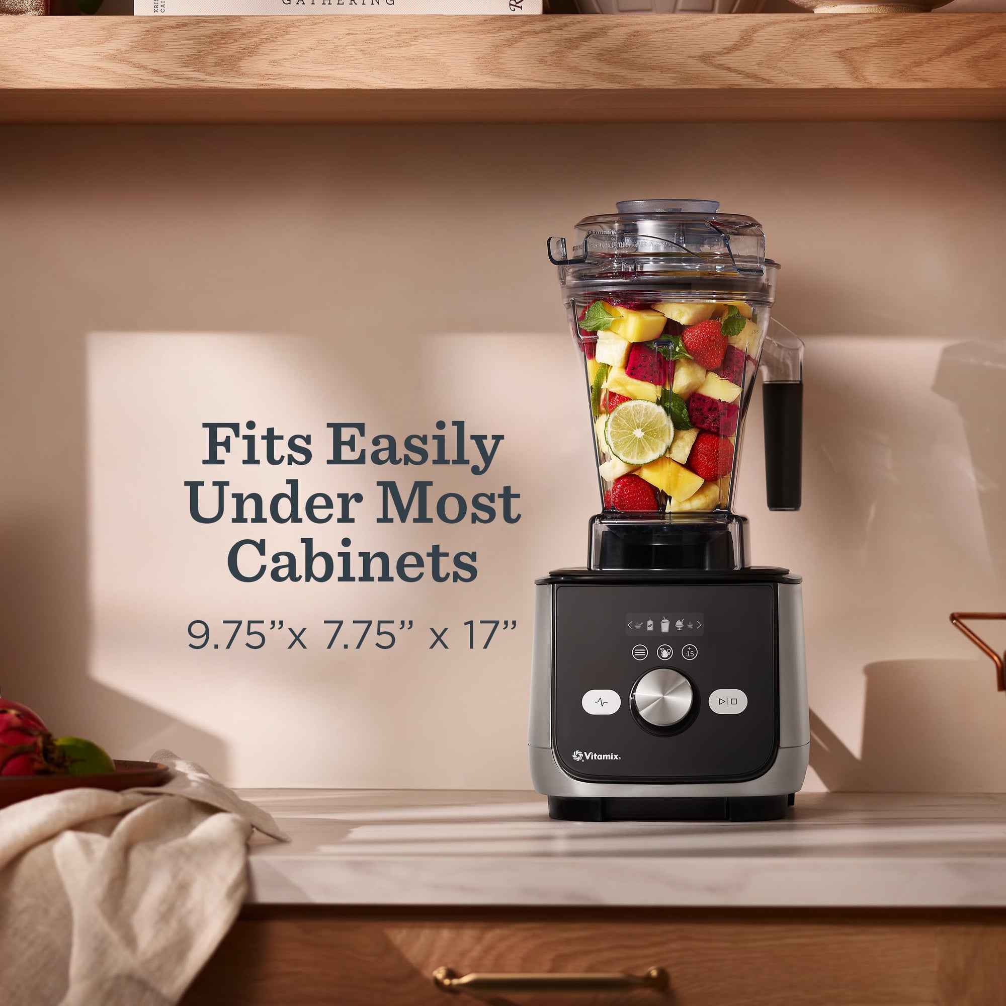 Blender with fruits on a kitchen counter, text indicating size and cabinet compatibility.