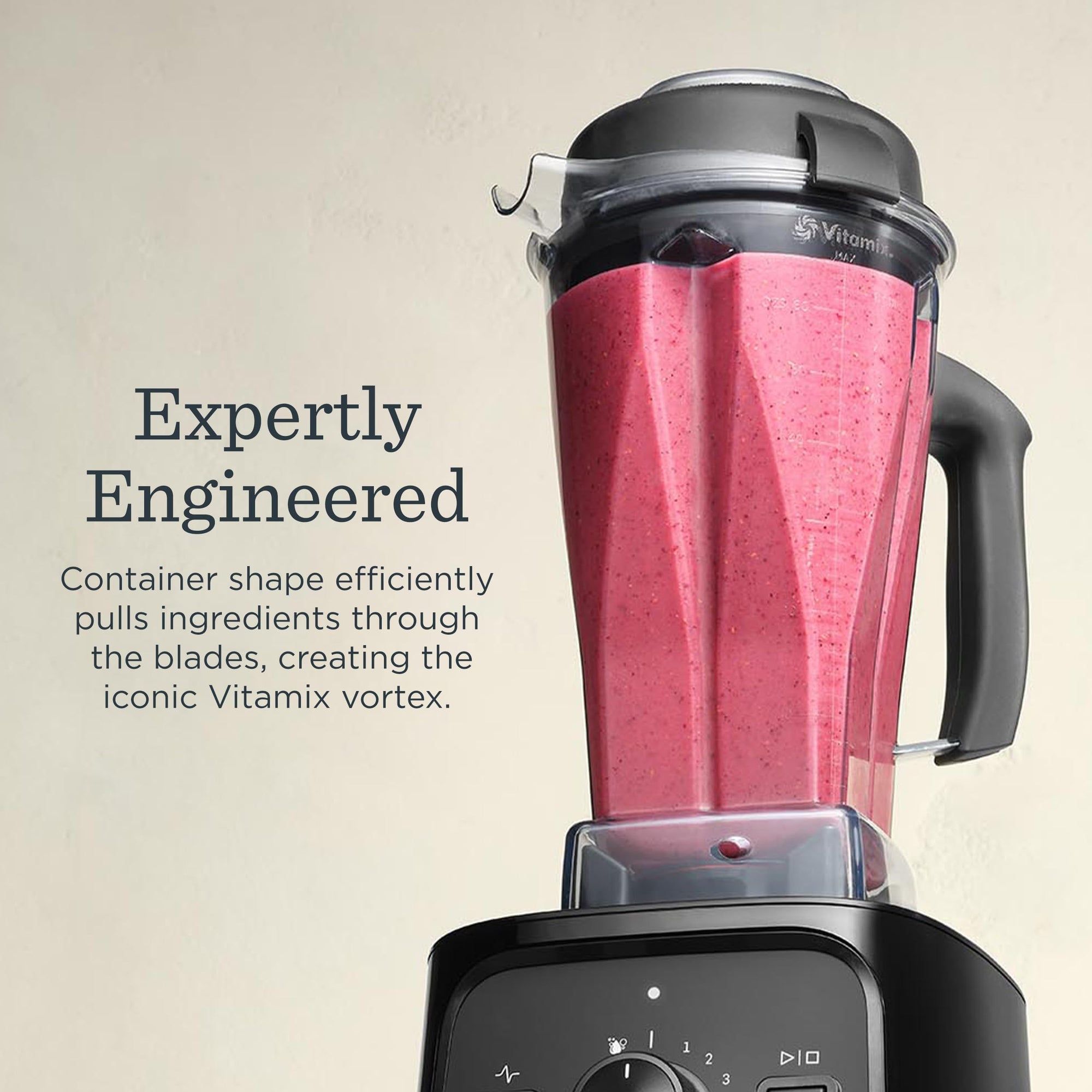 Vitamix blender with a pink smoothie inside on a beige background with a description about Expertly Engineered