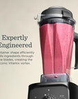 Vitamix blender with a pink smoothie inside on a beige background with a description about Expertly Engineered