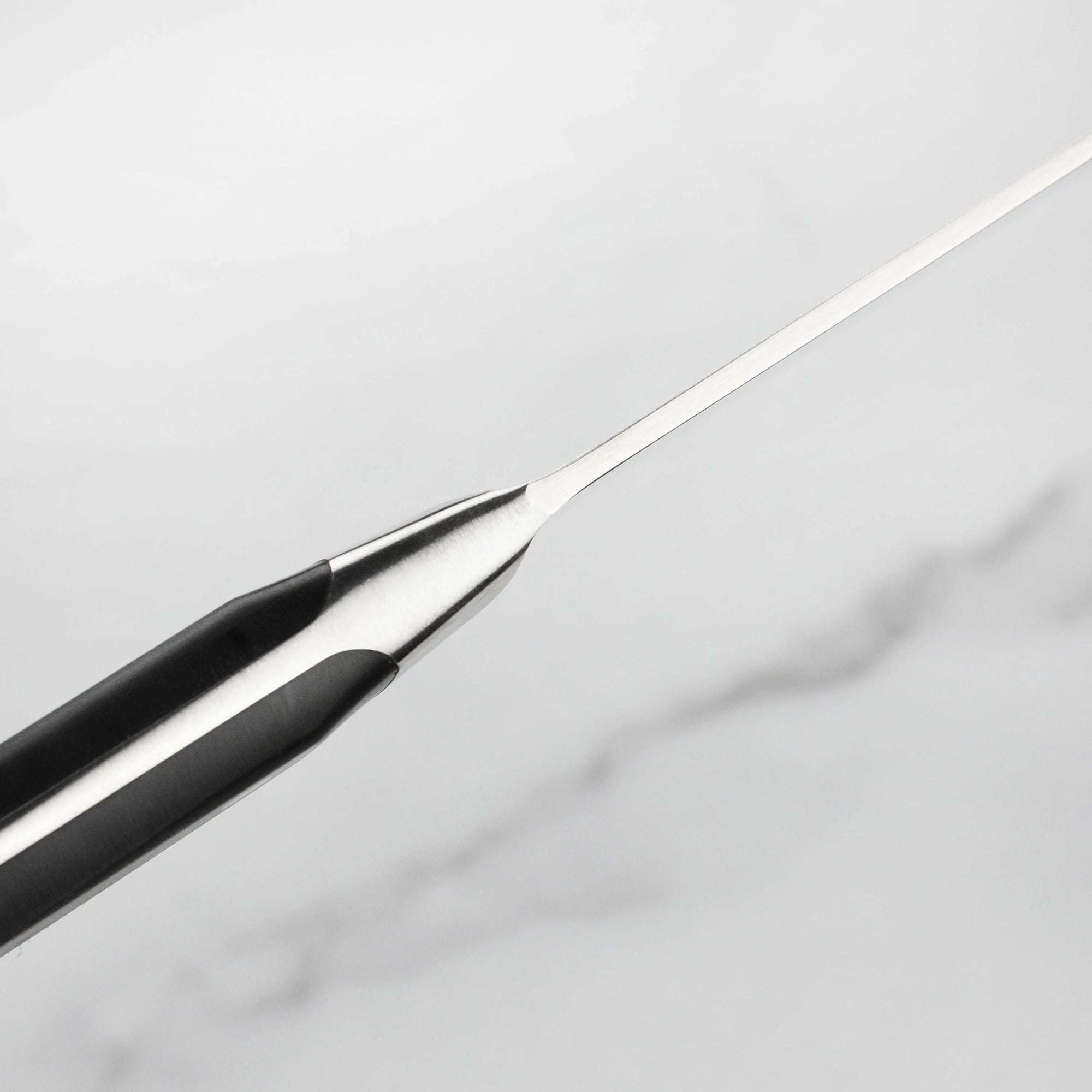 Close-up of a black and silver pen on a light gray background