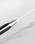 Close-up of a black and silver pen on a light gray background