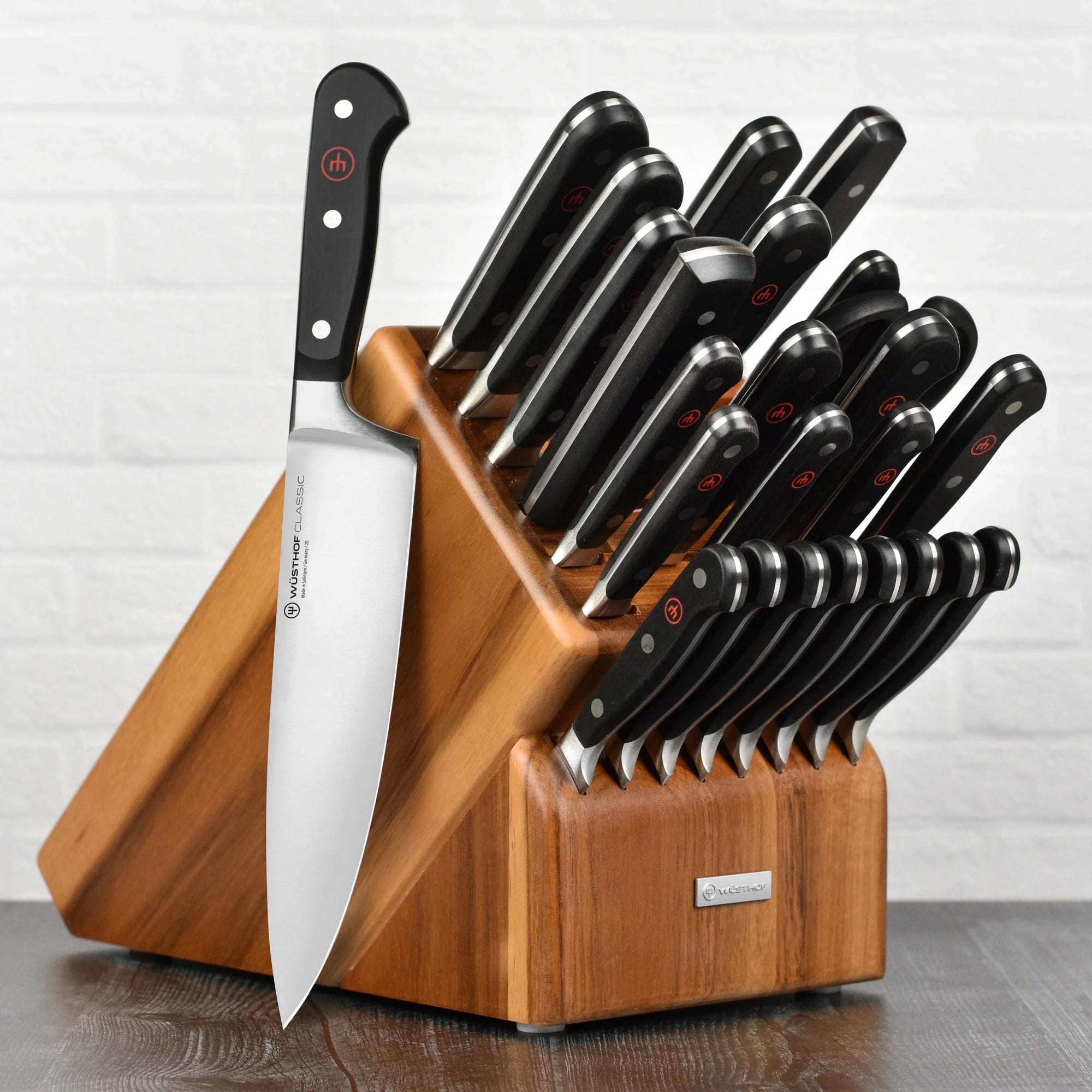 Set of knives in a wooden block on a white background