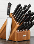 Set of knives in a wooden block on a white background