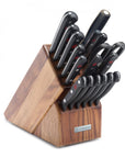 Set of knives in a wooden block on a white background